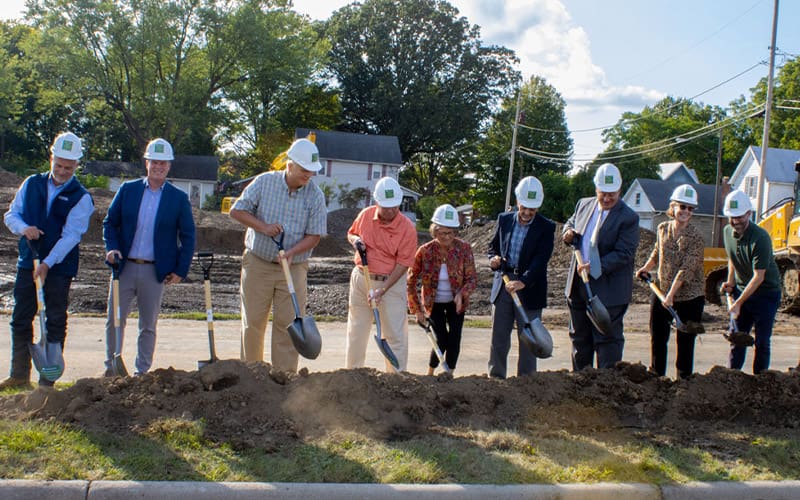 Community members posing with shovels for groundbreaking ceremony